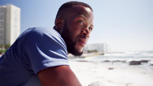 Thoughtful man leaning on the beach 4k