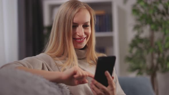 Woman on Couch with Smartphone