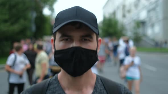 Opposition Person Protesting in Facemask Under Covid Epidemic Restrictions alt