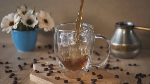 Pouring Coffee Into a Cup with Ice alt