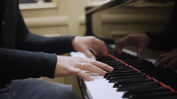 A Man Masterfully Plays the Piano Closeup alt