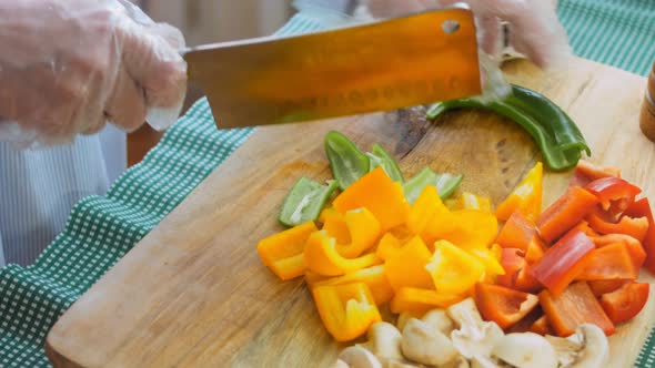 The Chef Cuts Green and Hot Peppers with a Professional Knife alt
