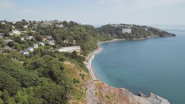 Panning from left to right over the ocean water and town of Torquay in England. Hotels are visible i alt