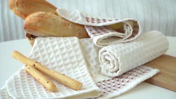Waffle Fresh Kitchen Towels on Background of Basket with Bread