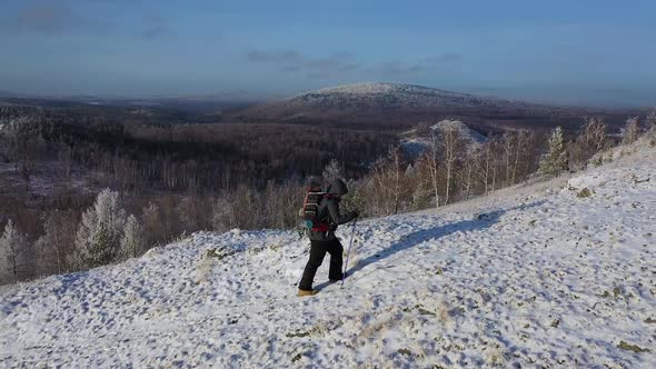 Lone Traveler Climbs to the Top of the Mountain Range alt