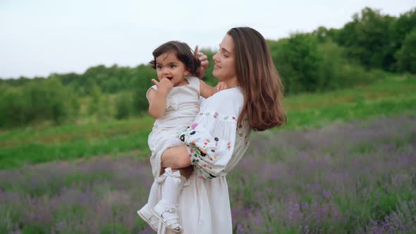 Mother Playing with Baby Girl in Lavender Field alt