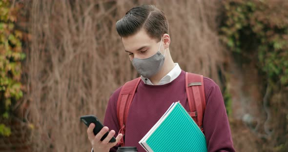 Portrait Male Student Mask Using Smartphone University Campus