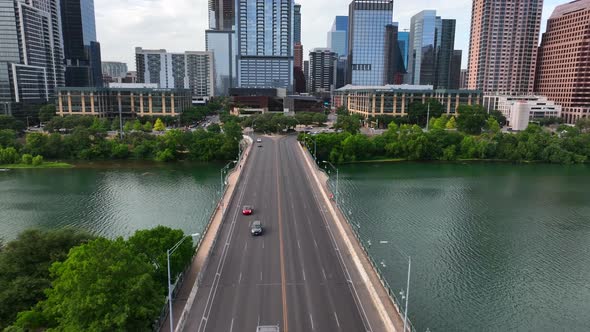 Austin Texas skyline. Aerial flight above Colorado River reveals downtown skyscrapers. alt