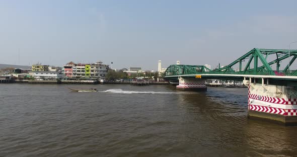 one Longtail boat driving on the main river in Bangkok, Thailand. alt