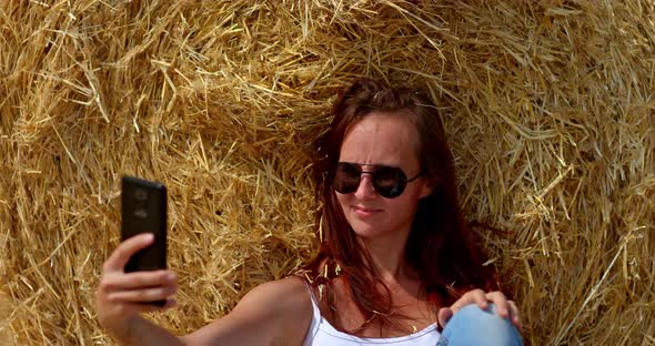 Portrait a Young Beautiful Woman Takes a Photo on a Smartphone She Smiles alt