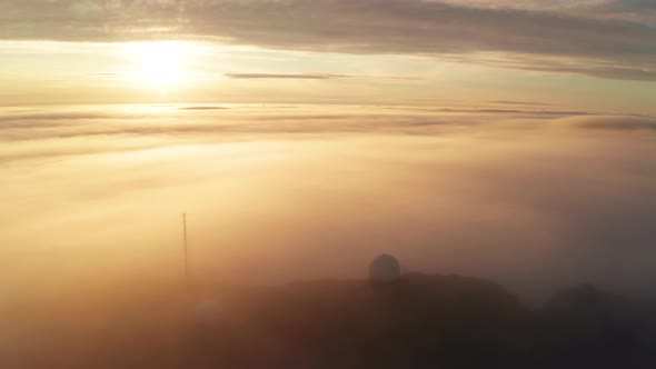 Aerial View of the Mountains in the Clouds at Sunset