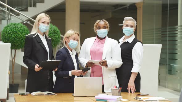 Group of Colleagues in Medical Masks in Office, During Coronavirus Pandemic alt