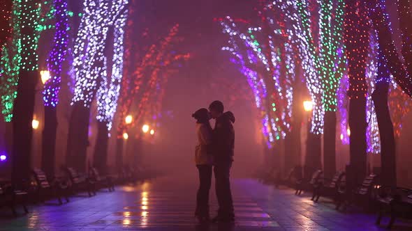 Couple kissing at night alley in Odesa, Ukraine