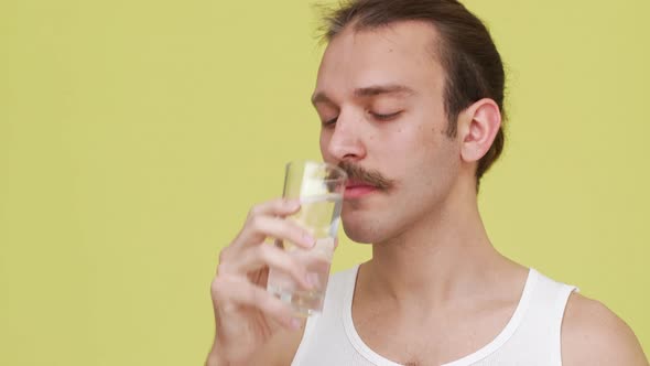 Closeup Darkhaired Man in Shirt Drinking Water From Glass with Pleisure Smiling Afterwards Over alt