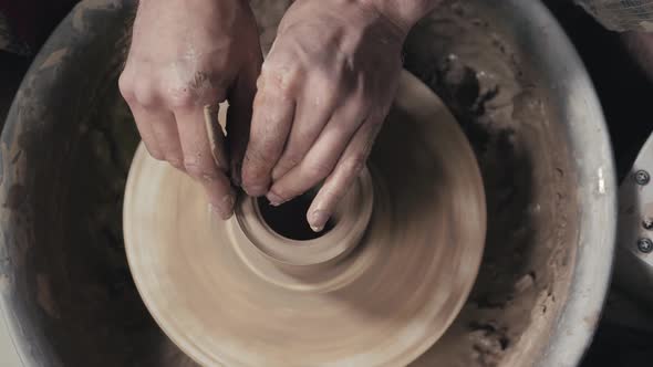 The Hands of a Potter Creating an Earthen Jar on the Circle Closeup Hands on Circle with Clay alt