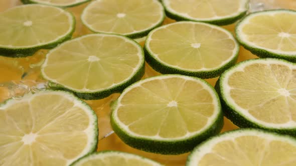 lime slices spread out on the table are poured with water