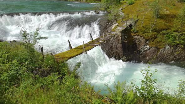 Suspension Bridge Over the Mountain River Norway alt
