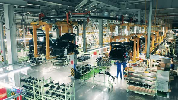 Black Coloured Car Body Moving Along a Conveyor alt