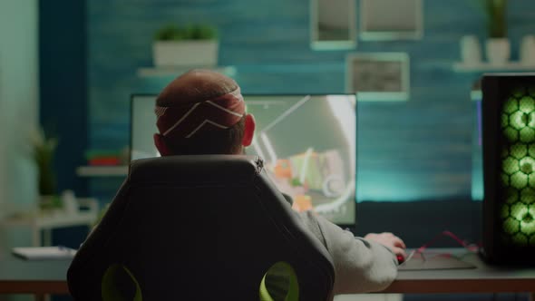 Back View of Pro Gamer Testing New Graphics of FPS Videogame alt