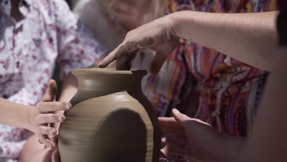 Young Couple Making Jug on Potter's Wheel, Slow Motion