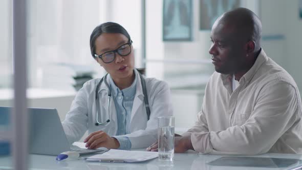 Modern Doctor Co-working With Colleague alt