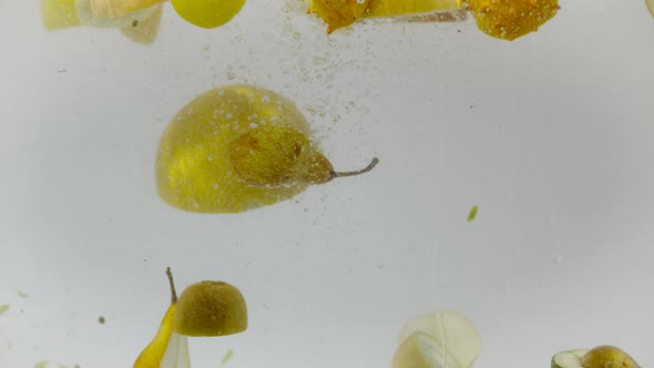 Sectioned fruits being dropped into water, Ultra Slow Motion alt