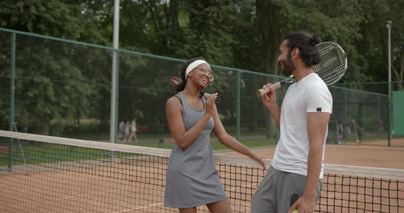 Couple of Tennis Players Talking at the Court After a Match alt