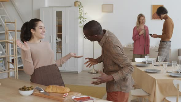 African Man and Mixed-race Woman Talking before Dinner alt