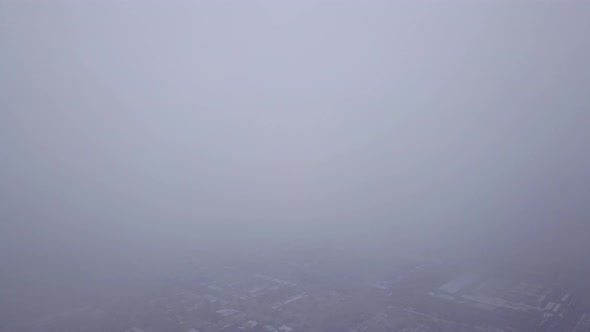 Top View Through the Clouds on the City of Almaty alt