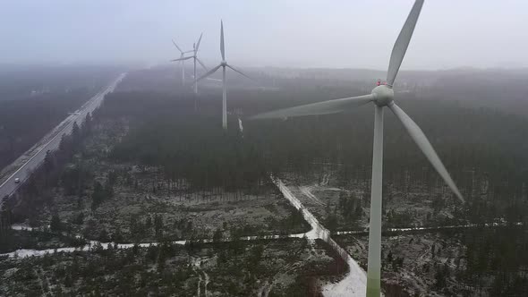 Closer Drone Shot of Wind Generators in Finland During a Foggy Day