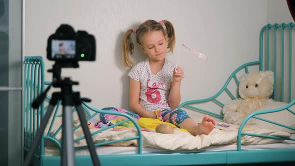Little Girl Shooting Vlog About Crafting at Home alt
