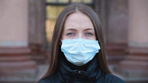 Portrait of a Young Woman Wearing Protective Mask on the Street