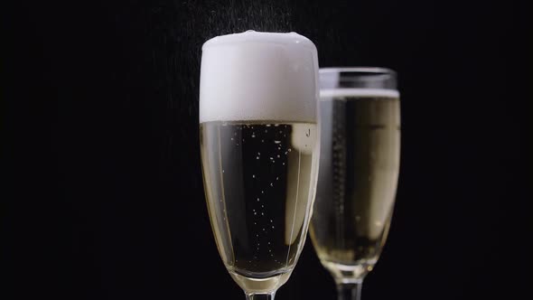 Waiter Pours the Champagne Into the Glass. Black Background. Close Up alt