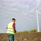 The Engineer Goes to the Windmills Power Turbines with the Tablet in His Hand - VideoHive Item for Sale
