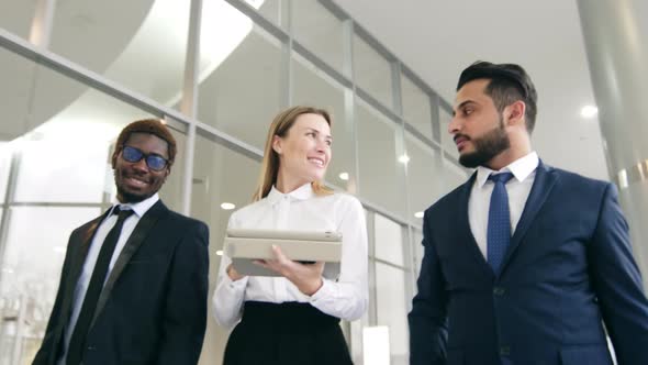 Group of business colleagues going inside office center