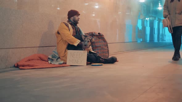 Underpass with a Beggar and a Dog Sitting on the Ground alt