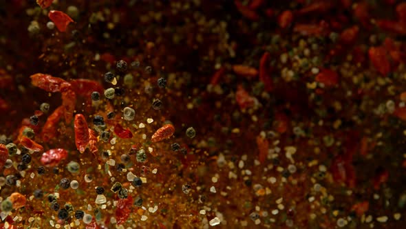 Super Slow Motion Shot of Colorful Seasoning Explosion on Black Background  alt