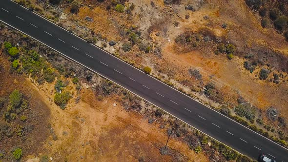 Top View of a Car Rides Along a Desert Road on Tenerife Canary Islands Spain alt