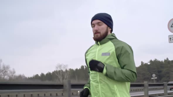 Man Practicing Jogging on Bridge alt