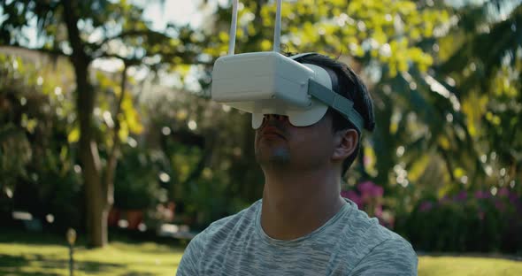 A Man in a Virtual Reality Helmet is Studying a Virtual Game alt