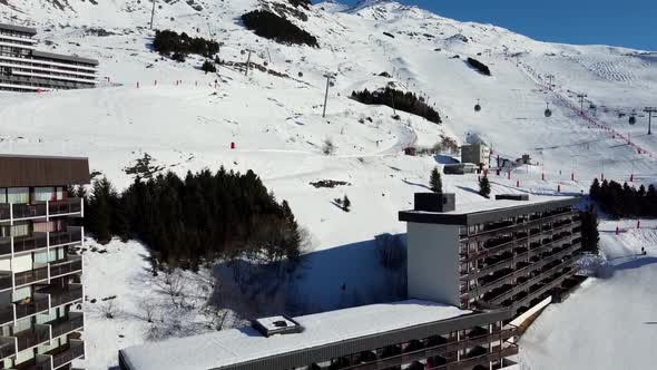 Majestic Winter Aerial Landscape and Ski Resort with Typical Alpine Wooden Houses in French Alps