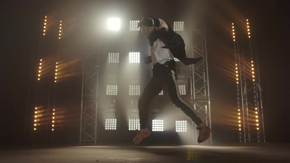 Breakdance Concept. Trendy Young Man Dancing Single in Club, Neon Light, Lots of Smoke. Fashion alt