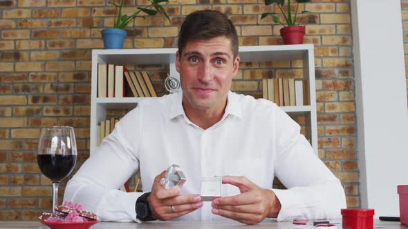 Caucasian man making video call presenting ring and making marriage proposal alt