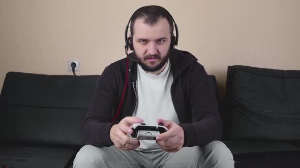 Serious Gamer with Headset Joystick Play Online Team Video Game, E-sports