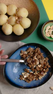 Vertical Flat Lay Video Chef Sprinkles Bread Crumbs on Potato Dumplings