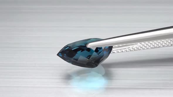 Natural London Blue Topaz Pear Cut in the Turning Tweezers