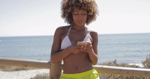 Charming Girl Using Smartphone While Training alt