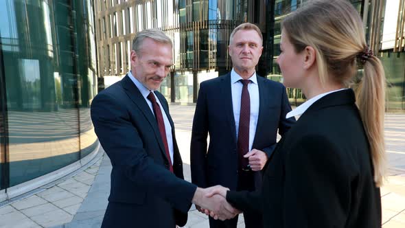 Woman Looking for Investors To Her Business Shaking Hands Businessmen Meeting Female Colleague in