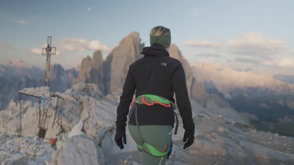 Female mountaineer walking in front of the famous three peaks - tre cime alt