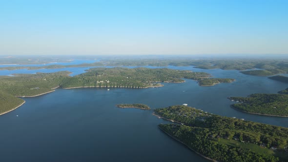 Aerial Birds Following View of a Hige River Bay and the Green Rainforest Under the Setting Sun